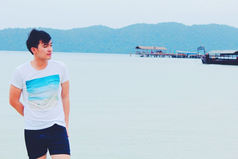 Standing over the calm sea water.