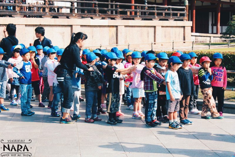 Kindergarten kids waiting in line for school field trip.